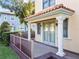 Outdoor porch with decorative pillars, a wooden deck, and inviting double doors at 608 Orange Ave, Clearwater, FL 33756