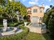 Beautiful backyard showcasing a fountain, manicured landscaping, and the home's elegant exterior at 608 Orange Ave, Clearwater, FL 33756