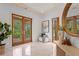 Bright foyer with tile flooring, decorative table, and doors leading to the balcony at 608 Orange Ave, Clearwater, FL 33756