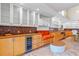Stylish kitchen with custom cabinets, a built-in wine cooler, and unique mosaic backsplash at 608 Orange Ave, Clearwater, FL 33756
