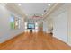 Bright living room with hardwood floors, built-in shelves, TV and recessed lighting at 608 Orange Ave, Clearwater, FL 33756