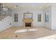 Spacious living room with a decorative fireplace, light stone floors and wrought iron staircase at 608 Orange Ave, Clearwater, FL 33756
