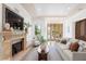Comfortable living room featuring a fireplace and views of the outdoor pool at 608 Orange Ave, Clearwater, FL 33756