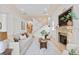 Bright living room with decorative fireplace, staircase and comfortable seating at 608 Orange Ave, Clearwater, FL 33756