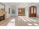 Bright living room with a fireplace, wood framed windows and doors leading to the outdoor pool at 608 Orange Ave, Clearwater, FL 33756