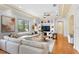 Bright and spacious living room with coffered ceilings, large windows, and hardwood floors at 608 Orange Ave, Clearwater, FL 33756
