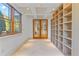 Bright office space featuring tile floors, large built-in shelves, and recessed lighting at 608 Orange Ave, Clearwater, FL 33756