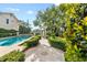 Lush backyard featuring a sparkling pool, manicured landscaping, and fountain with a gazebo at 608 Orange Ave, Clearwater, FL 33756
