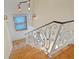 Grand staircase with decorative wrought iron railings and detailed woodwork, illuminated by elegant sconces at 608 Orange Ave, Clearwater, FL 33756