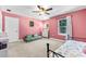 Pink bedroom with a cozy seating area, stylish decor and a window for natural light at 6318 S Harold Ave, Tampa, FL 33616