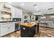 Open kitchen view with island, stainless appliances, and seamless flow into the living area at 6318 S Harold Ave, Tampa, FL 33616