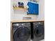 Convenient laundry room features modern appliances and upper cabinets at 6318 S Harold Ave, Tampa, FL 33616