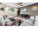 Bright living room featuring stylish furniture, a ceiling fan, and a television at 6318 S Harold Ave, Tampa, FL 33616