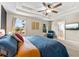 Spacious main bedroom boasts tray ceilings, a ceiling fan, and a sitting area at 6318 S Harold Ave, Tampa, FL 33616