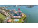 Panoramic aerial view of condo building near water featuring a swimming pool and surrounding greenery at 6372 Palma Del Mar S Blvd # 1007, St Petersburg, FL 33715