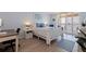 Serene bedroom featuring light wood floors and a balcony offering tranquil views at 6372 Palma Del Mar S Blvd # 1007, St Petersburg, FL 33715