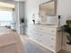 Bright bedroom featuring a dresser and stylish decor leading to a private balcony at 6372 Palma Del Mar S Blvd # 1007, St Petersburg, FL 33715