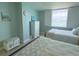 Charming bedroom with light green walls featuring twin beds and window with waterfront view at 6372 Palma Del Mar S Blvd # 1007, St Petersburg, FL 33715