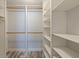 A well-organized closet with custom shelving, wooden rods, and light wood floors at 6372 Palma Del Mar S Blvd # 1007, St Petersburg, FL 33715