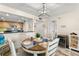 Dining area with seating for four, modern light fixture, and an open view of the kitchen at 6372 Palma Del Mar S Blvd # 1007, St Petersburg, FL 33715