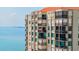 Exterior shot of the condo building featuring many balconies overlooking the tranquil water at 6372 Palma Del Mar S Blvd # 1007, St Petersburg, FL 33715