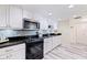Well-lit kitchen featuring updated white cabinets, stainless steel appliances, and granite countertops at 6372 Palma Del Mar S Blvd # 1007, St Petersburg, FL 33715