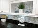 Well-decorated kitchen featuring white cabinets, granite countertops, and a stylish backsplash at 6372 Palma Del Mar S Blvd # 1007, St Petersburg, FL 33715