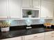 Bright kitchen featuring white cabinets, granite countertops, and a stylish backsplash at 6372 Palma Del Mar S Blvd # 1007, St Petersburg, FL 33715