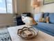 Close up on decorative fish sculpture in the living room with cozy furniture and water view at 6372 Palma Del Mar S Blvd # 1007, St Petersburg, FL 33715