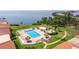 Resort style community pool and spa with tiki umbrellas and bay views at 6372 Palma Del Mar S Blvd # 1007, St Petersburg, FL 33715