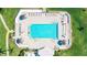 Aerial view of rectangular community pool featuring lounge chairs and tiki umbrellas on sunny day at 6372 Palma Del Mar S Blvd # 1007, St Petersburg, FL 33715