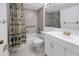 Bathroom with vanity, commode, tub with shower, and safety bars at 6826 Stones Throw N Cir # 11104, St Petersburg, FL 33710