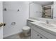 Bathroom with a white vanity, toilet, mirror and updated shower with tile surround at 6826 Stones Throw N Cir # 11104, St Petersburg, FL 33710