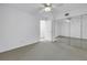 Spacious bedroom featuring mirrored closet doors, neutral carpet, and a ceiling fan at 6826 Stones Throw N Cir # 11104, St Petersburg, FL 33710