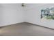 Bright bedroom with a ceiling fan and a view of the outside from the window at 6826 Stones Throw N Cir # 11104, St Petersburg, FL 33710