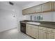 Functional kitchen features dark granite countertops, wood cabinets, and a view to the outdoor scenery at 6826 Stones Throw N Cir # 11104, St Petersburg, FL 33710