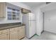 Efficient kitchen featuring a refrigerator, wooden cabinets and view to the exterior at 6826 Stones Throw N Cir # 11104, St Petersburg, FL 33710