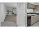 Open-concept living room with kitchen bar, tile flooring, carpet and screened patio access at 6826 Stones Throw N Cir # 11104, St Petersburg, FL 33710
