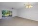 Light and airy living room space featuring plush carpeting, sliding doors to the covered patio, and ceiling fan at 6826 Stones Throw N Cir # 11104, St Petersburg, FL 33710