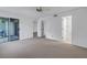 Carpeted primary bedroom with large sliding glass doors to patio and access to closet and bathroom at 6826 Stones Throw N Cir # 11104, St Petersburg, FL 33710