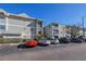 Exterior view of condo buildings with parking area and well-maintained landscaping, offering a convenient living space at 6826 Stones Throw N Cir # 11104, St Petersburg, FL 33710