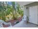 Patio with chairs surrounded by lush tropical landscaping at 6826 Stones Throw N Cir # 11104, St Petersburg, FL 33710