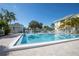 Bright community pool with clear water, white lounge chairs and lush tropical landscaping, perfect for relaxation at 6826 Stones Throw N Cir # 11104, St Petersburg, FL 33710