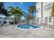 Community spa with tropical landscaping surrounded by lounge chairs at 6826 Stones Throw N Cir # 11104, St Petersburg, FL 33710