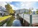 Scenic view of the community with a peaceful water feature, bridge and buildings with lush landscaping at 6826 Stones Throw N Cir # 11104, St Petersburg, FL 33710
