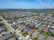 Beautiful aerial view of a well-maintained community with a lake and city skyline in the distance on a sunny day at 7510 Lantern Park Ave, Apollo Beach, FL 33572