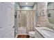 Well-appointed bathroom featuring a shower-tub combination with a stylish shower curtain and accent wall at 7510 Lantern Park Ave, Apollo Beach, FL 33572