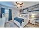 Bedroom with blue accents, a ceiling fan, and matching nightstands with lamps at 7510 Lantern Park Ave, Apollo Beach, FL 33572