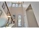 Grand foyer with soaring ceilings, staircase, statement chandelier, and decorative front door at 7510 Lantern Park Ave, Apollo Beach, FL 33572