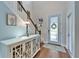 Bright foyer with hardwood floors, white console table, and a decorative front door with glass panel at 7510 Lantern Park Ave, Apollo Beach, FL 33572